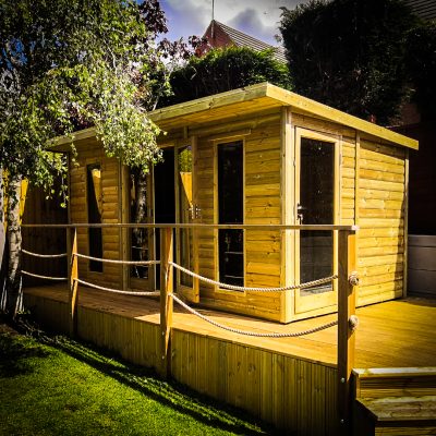 Bespoke summerhouse installed on elevated decking manufactured and installed by Viking Garden Buildings in Stafford